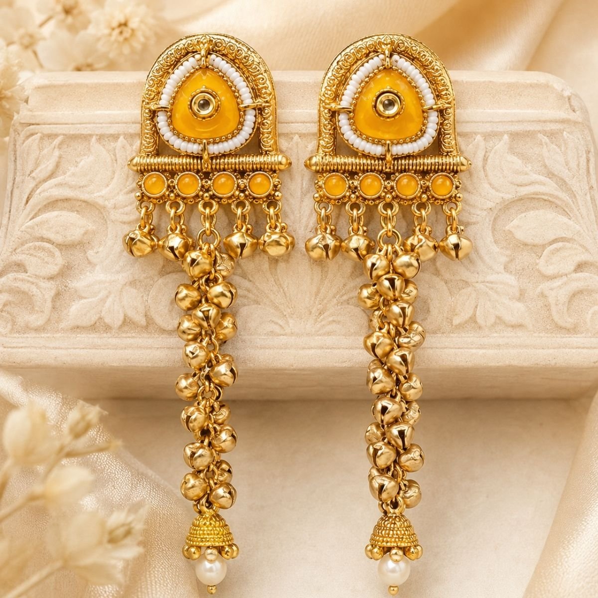 Gold-tone mustard yellow temple style long ghungroo earrings with white beads and pearl jhumka drops